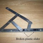 Broken window hinges showing a broken plastic slider Bexleyheath